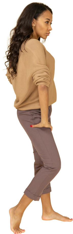 Side view of a dark-skinned young female putting hand on hip