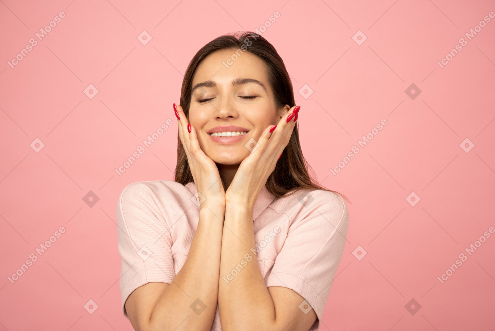 Attractive young girl smiling and touching her face with both hands