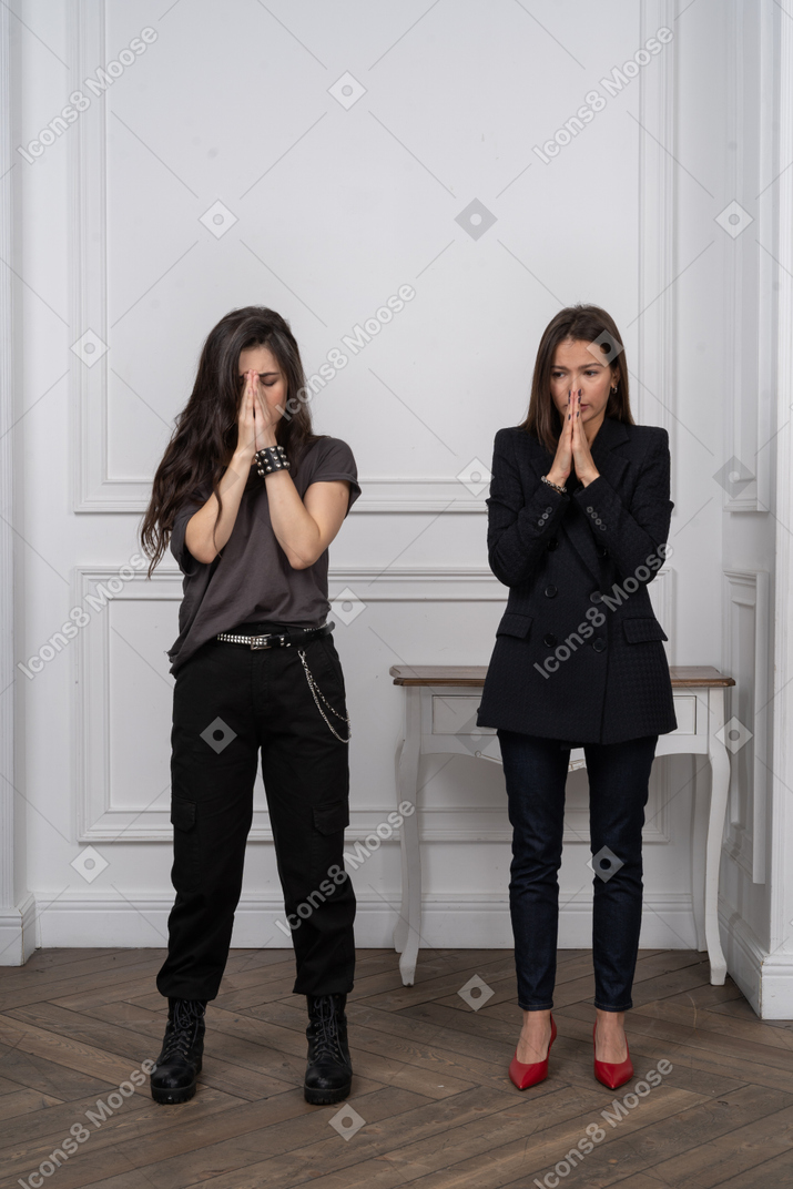 Two young women praying