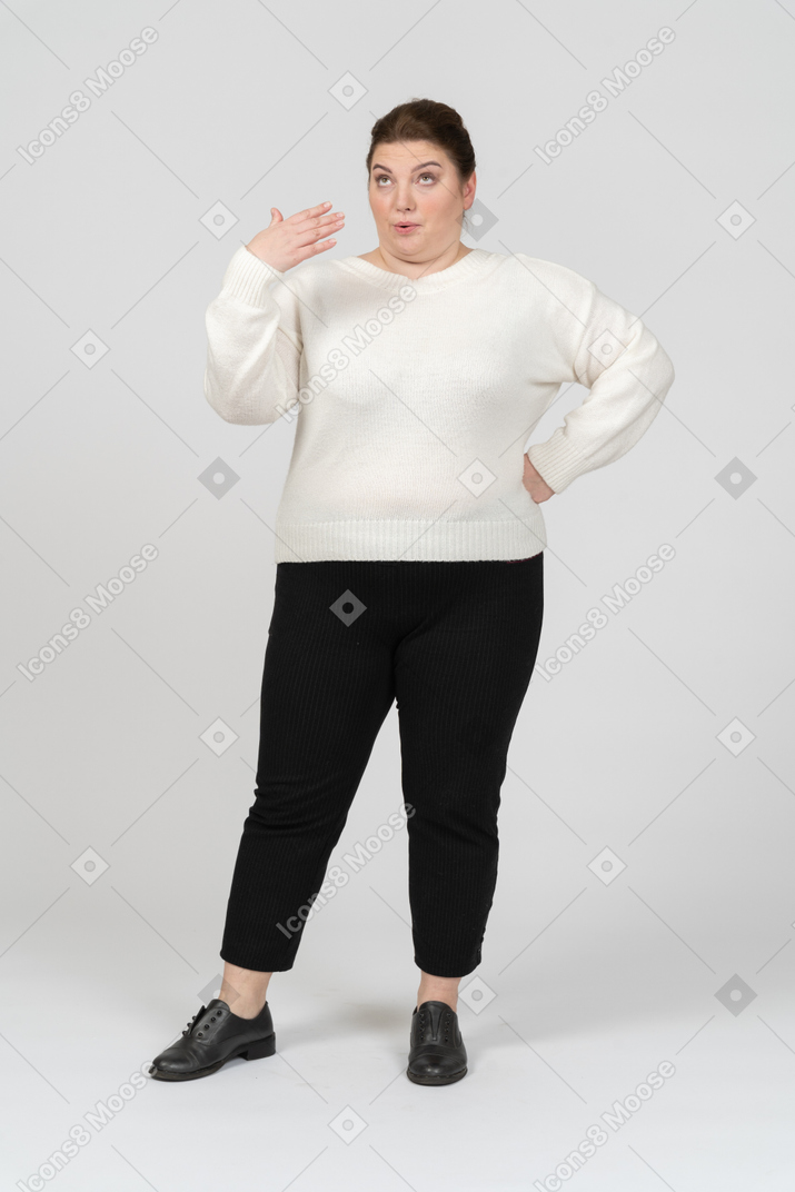 Confident plump woman in casual clothes posing