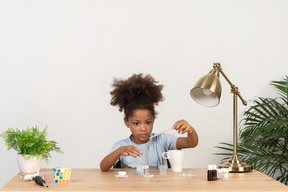 Good looking cute girl doing science at the table