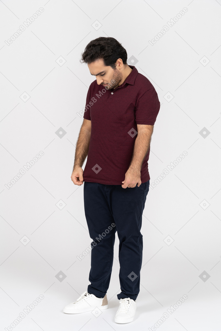 Upset man in casual clothes with head down