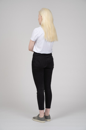 Rear view of a standing young girl