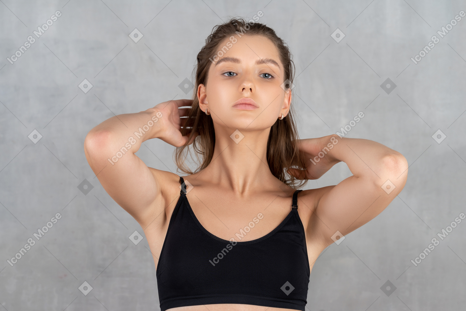 Young woman posing with hands behind her head