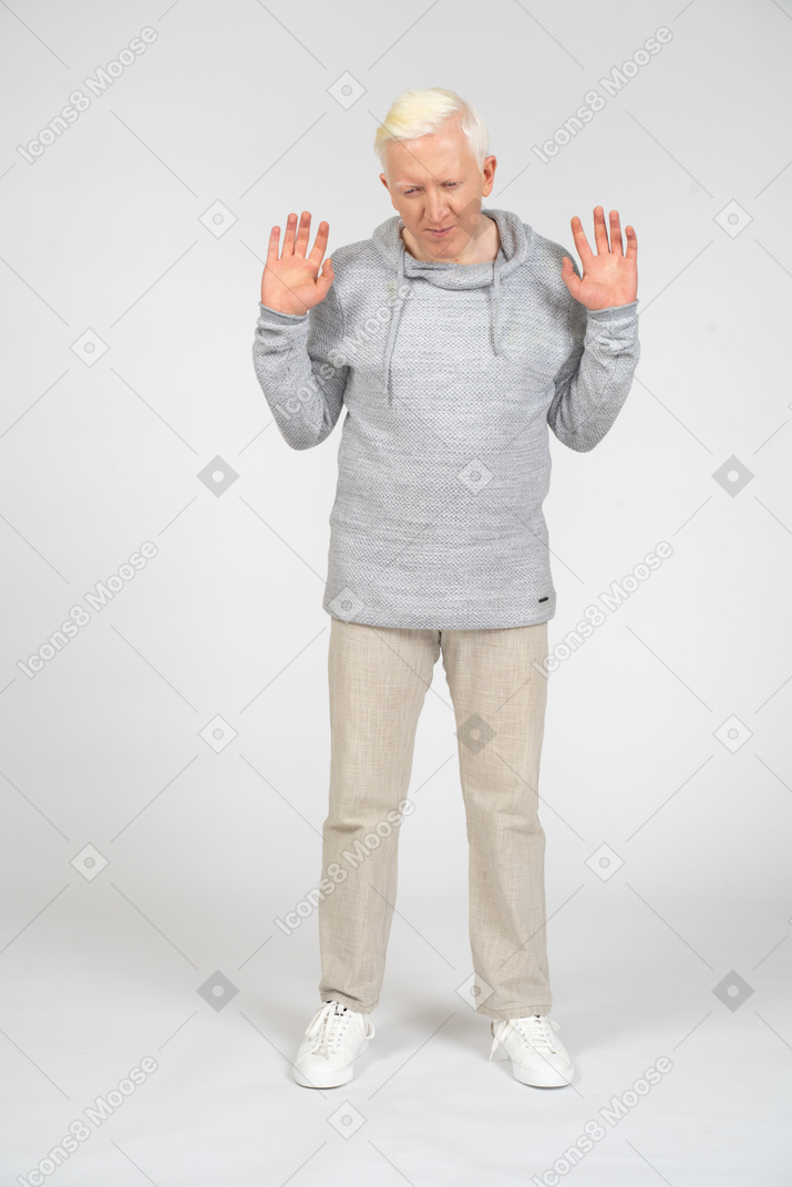 Man lifting his hands with palms facing the camera