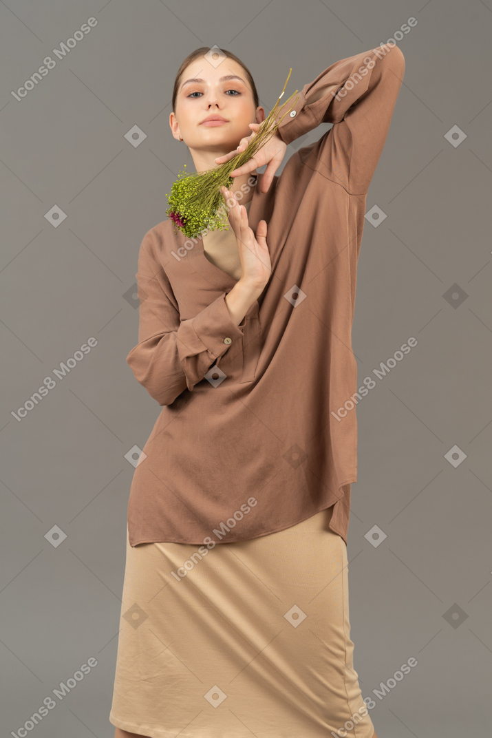 Young woman posing with bouquet