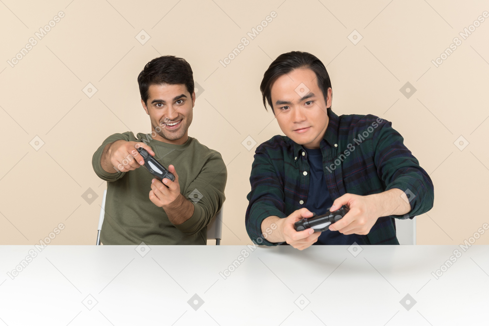 Interracial friends sitting at the table and playing video game
