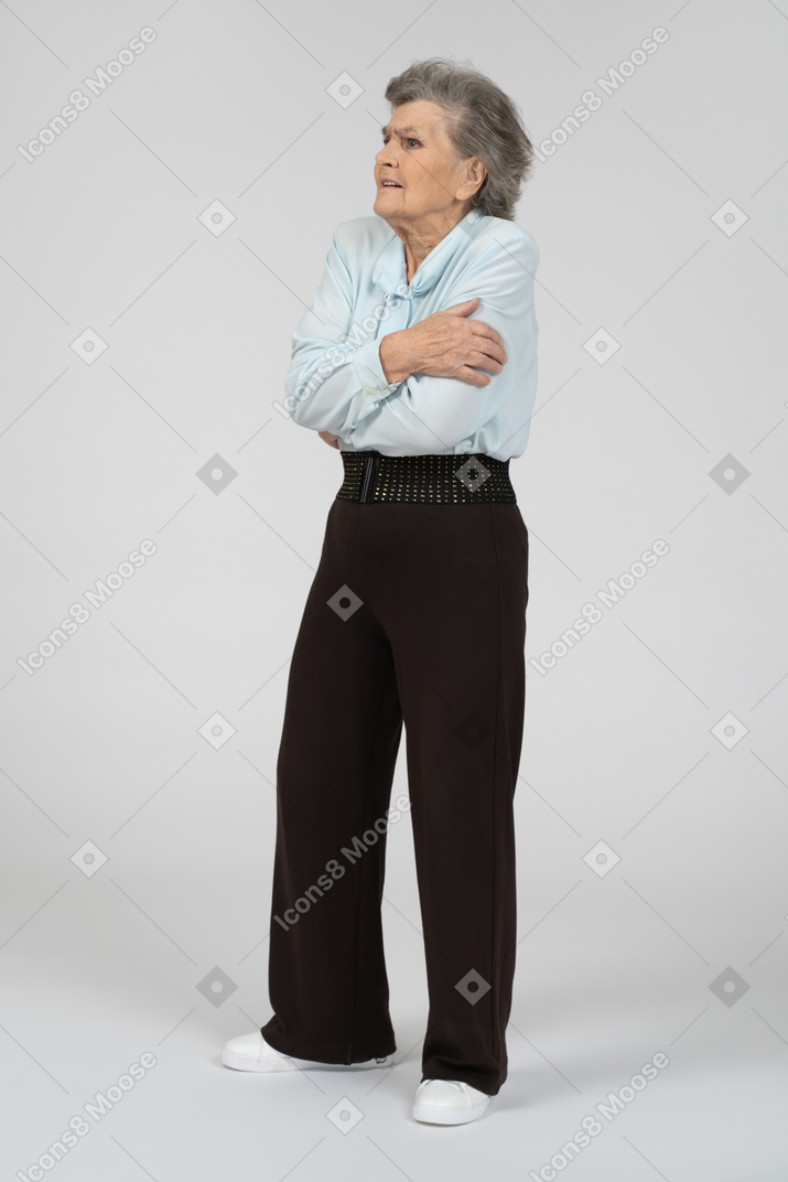 Elderly lady standing with crossed arms