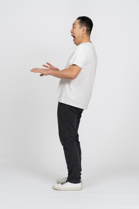 Side view of an impressed man in casual clothes