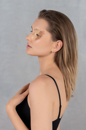 Profile view of a young woman with different shades of foundation on her face