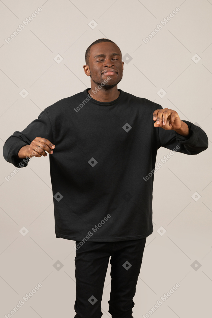 Young man dancing with eyes closed