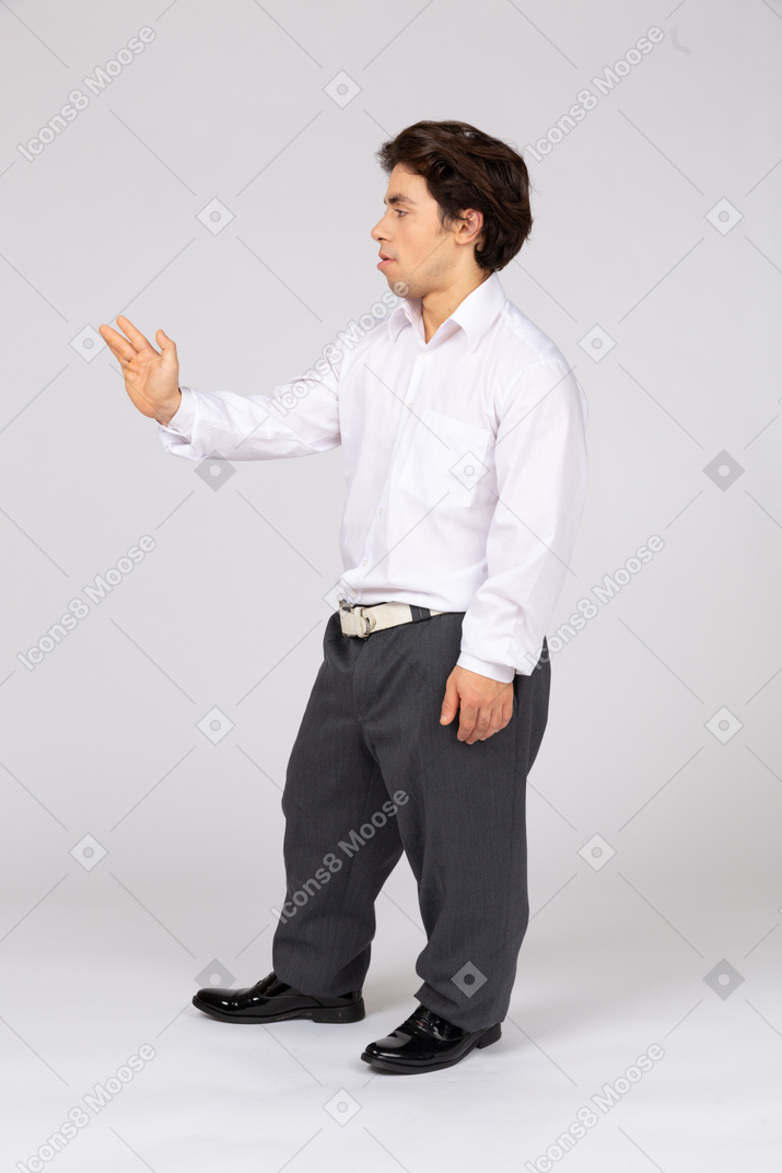 Side view of an office worker holding his hand out
