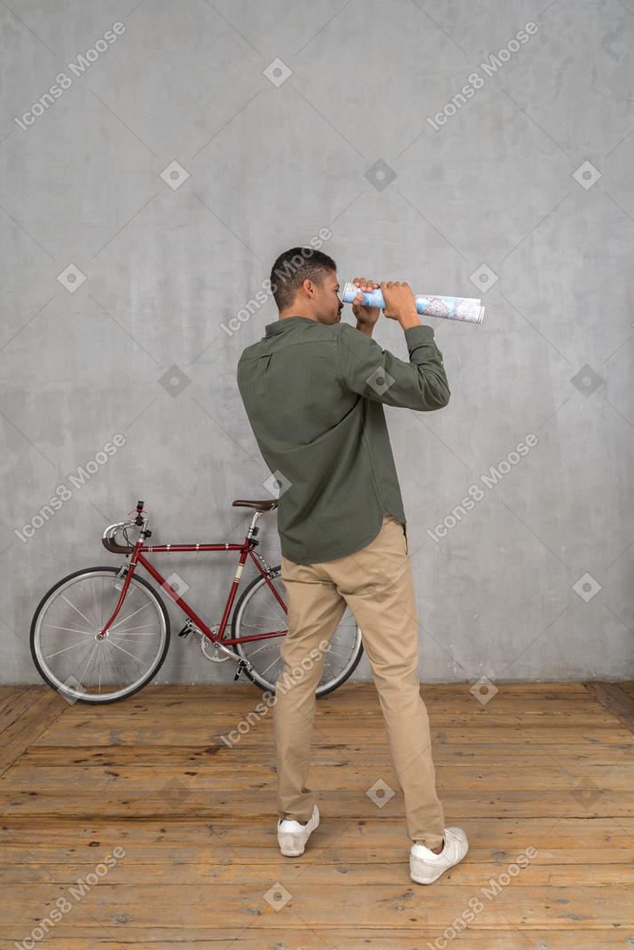 Man looking into the map telescope like