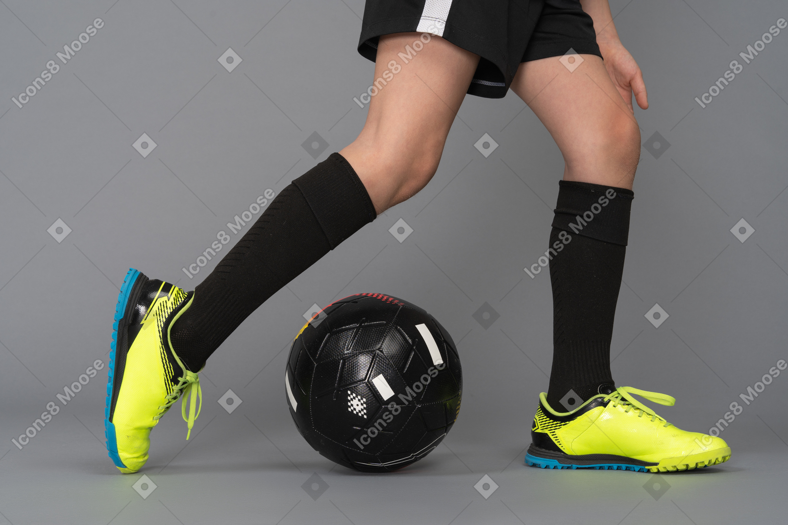 A soccer player is kicking a soccer ball