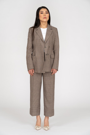 Front view of a young lady in brown business suit looking straight