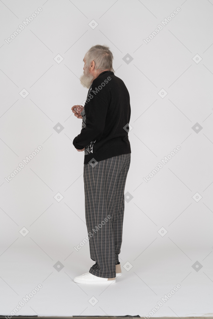 Side view of old man standing and gesturing
