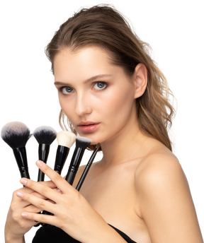 Three-quarter view of a sensual young woman holding make-up brushes