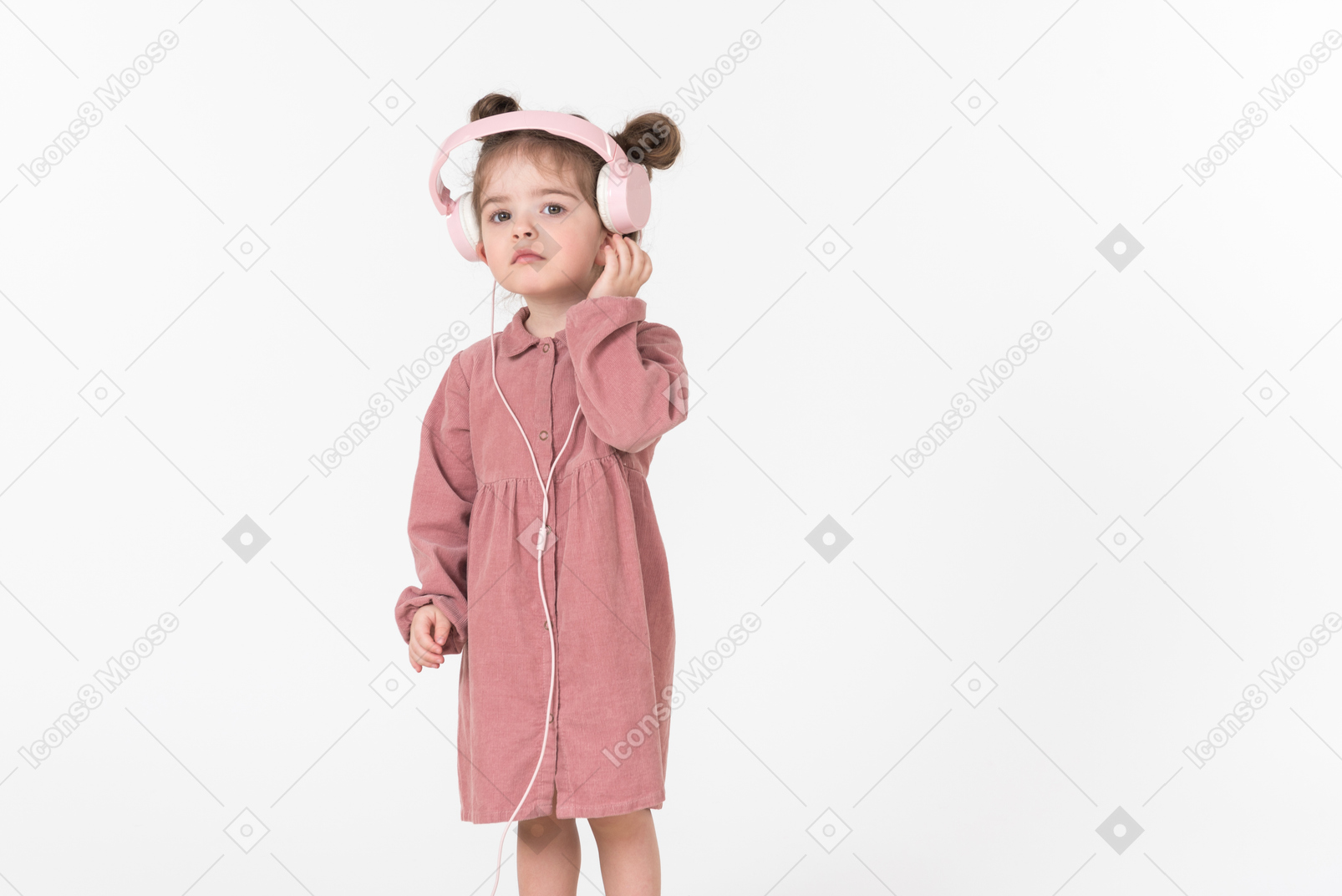 Funny looking kid girl wearing pink headphones