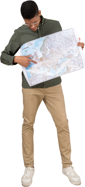 Front view of a man looking and pointing at a map