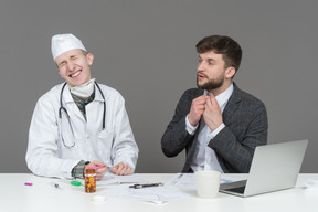 A doctor laughing with their patient