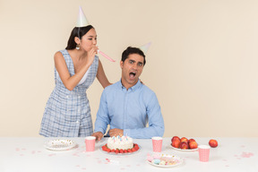 Young woman whistling right into her partner's ear