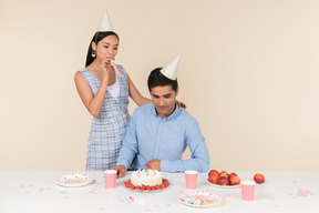 Joven pareja interracial celebrando el cumpleaños del hombre