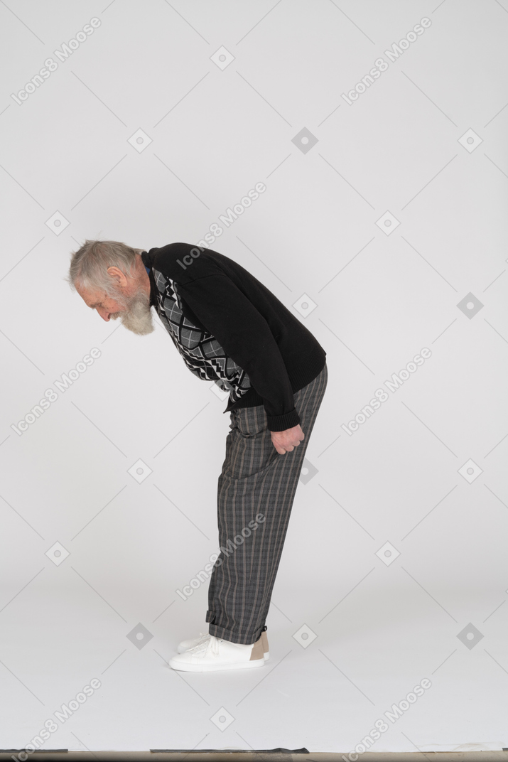 Side view of an elderly man bending over