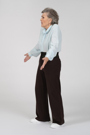 Vista laterale di una donna anziana che scrolla le spalle in questione
