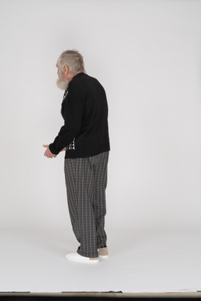 Three-quarter back view of an old man