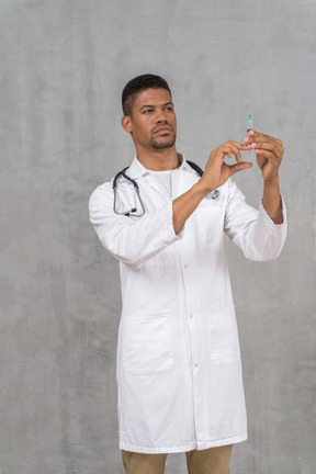 Male doctor preparing a syringe