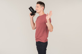 Young guy holding a photo camera