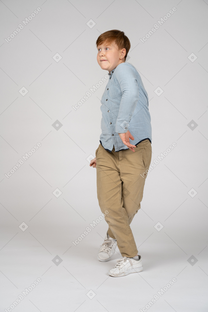 A young boy doing an unusual walk