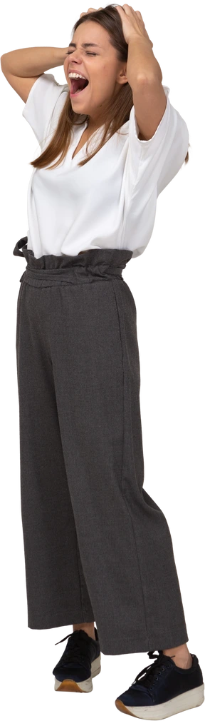 Three-quarter view of a yawning young lady in office clothing touching head