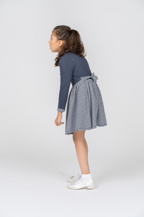 Three-quarter back view of a girl leaning forward