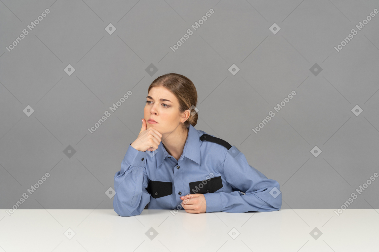 A thoughtful female security guard touching her chin