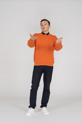 Young man in orange sweatshirt standing
