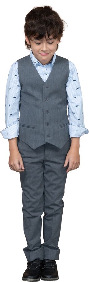 Front view of a cute boy in suit looking down