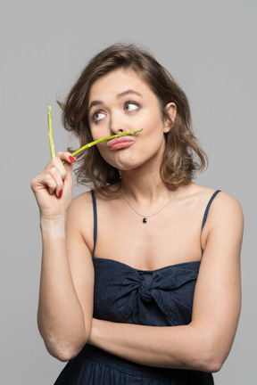 Portrait of a funny girl with asparagus