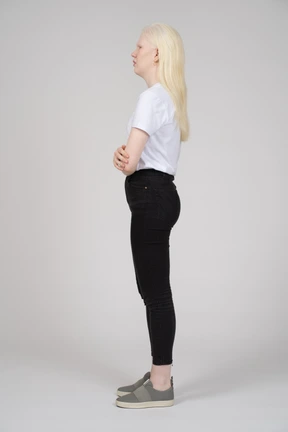 Side view of a young woman with folded arms