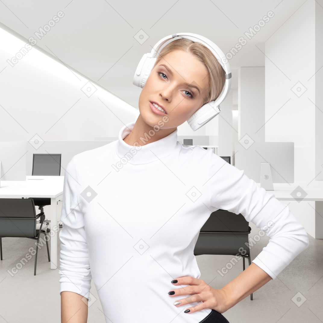 A woman wearing headphones standing in an office