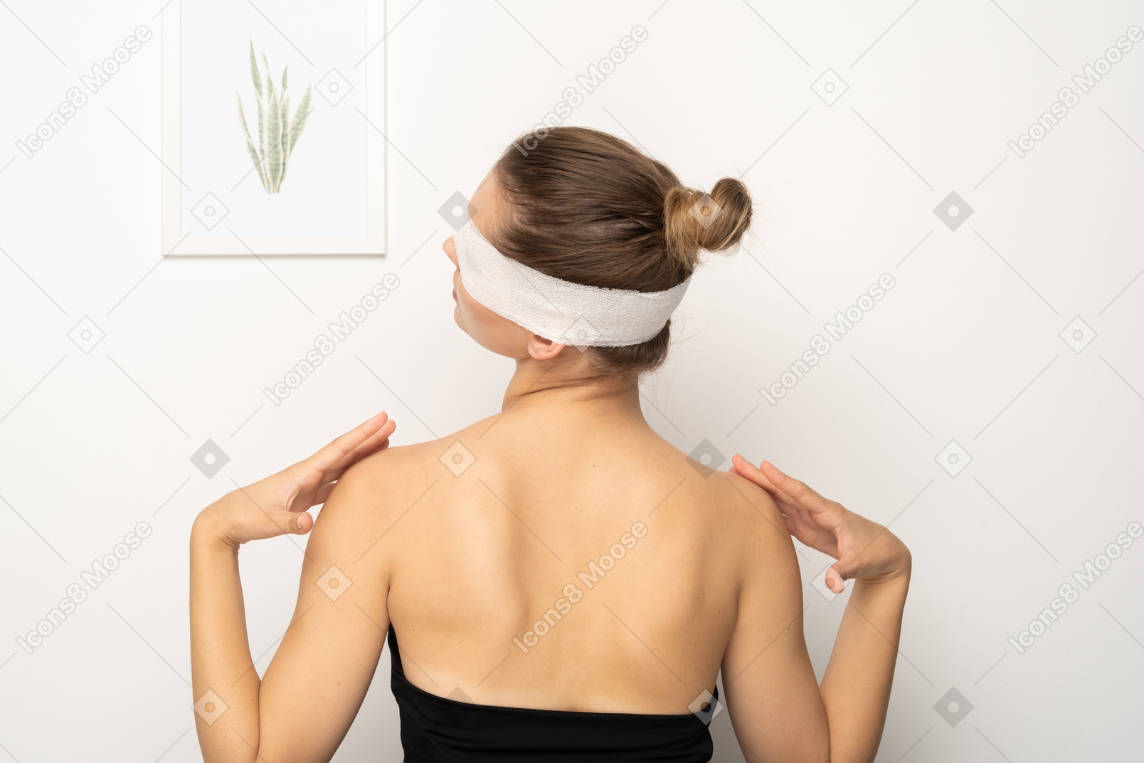 Woman with bandage over her eyes touching shoulders