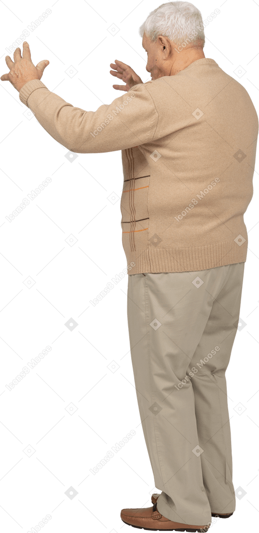 Old man in casual clothes showing size of something