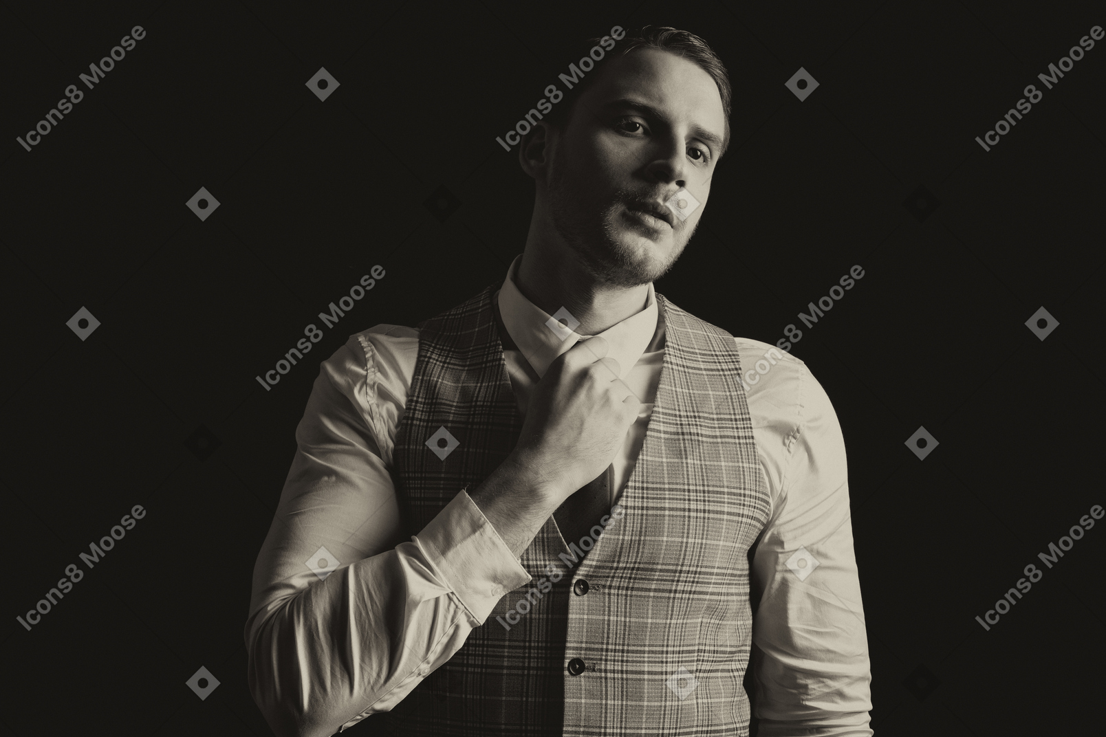 Gentleman in a suite adjusting tie