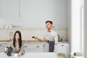 A man and a woman in a kitchen