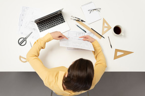 A female architect pointing at the drawing