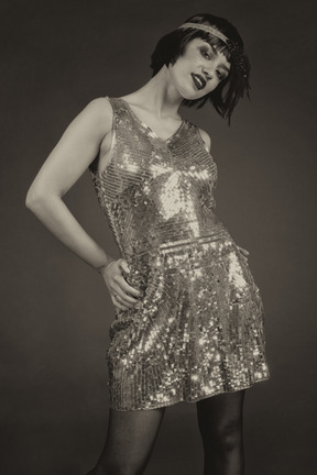 Retro-styled female posing in sequin shiny dress