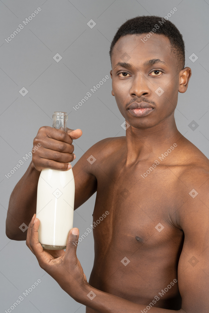 Young man with a bottle of milk