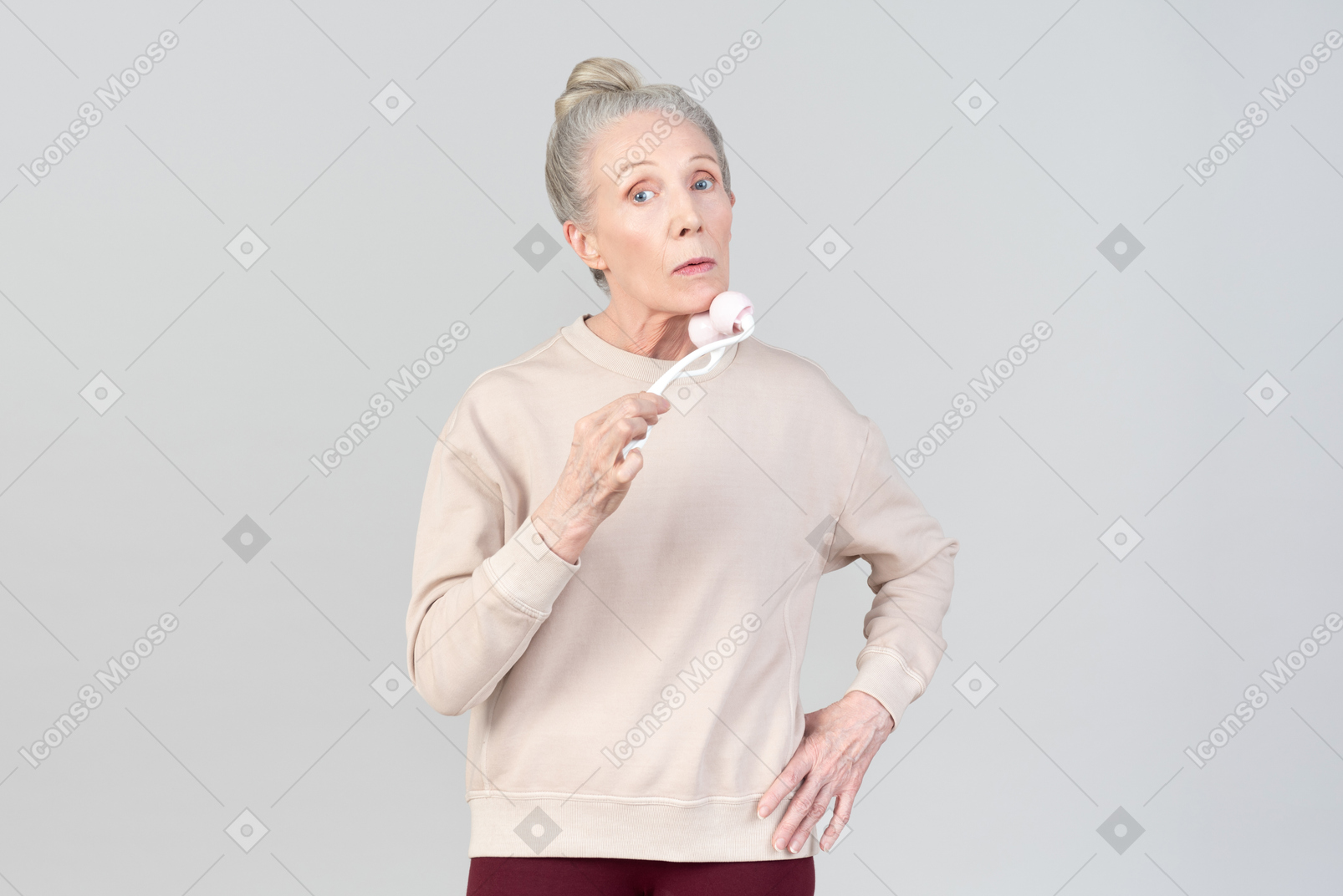 Old lady with face massage roller