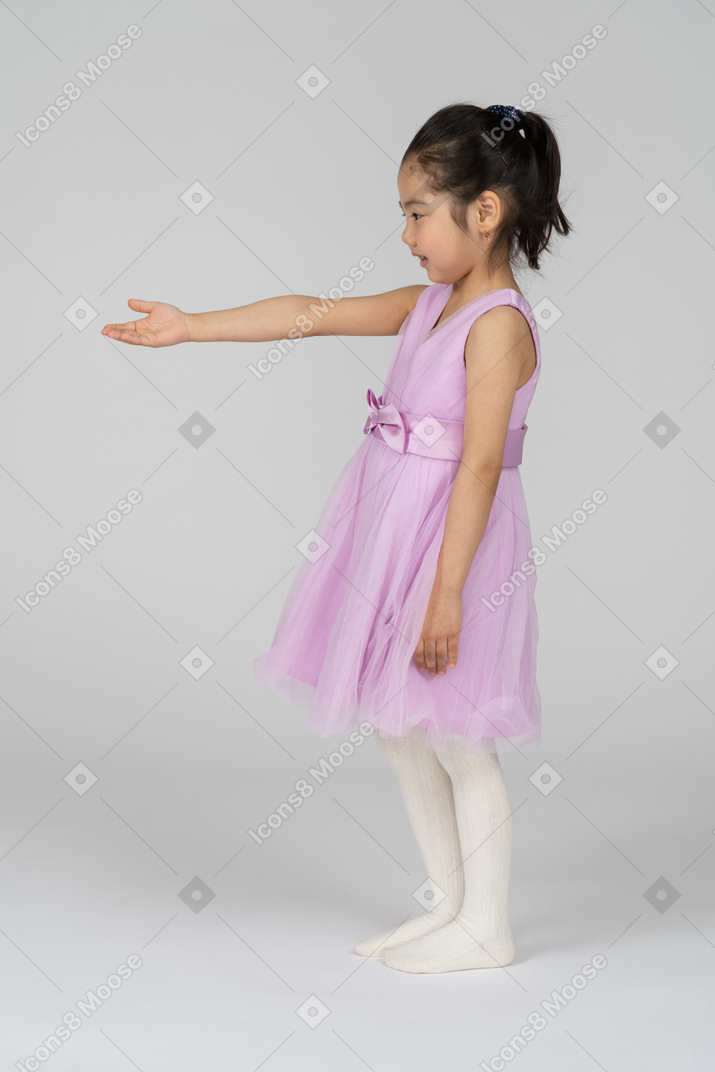 Side view of a pretty girl reaching out her arm