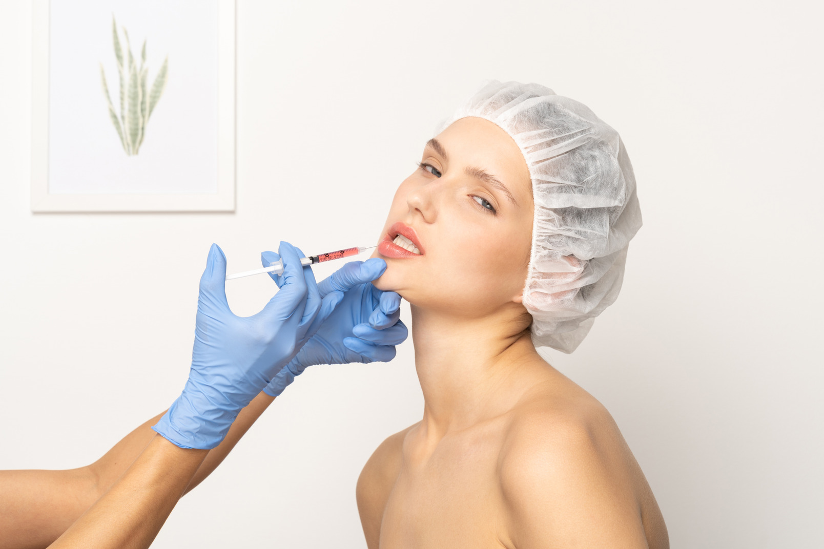 Woman looking tense during lip injection